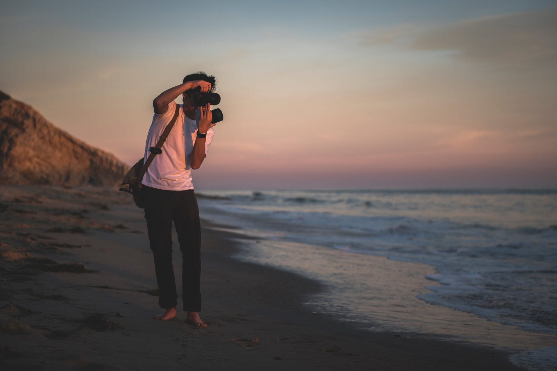 man taking photo at beach